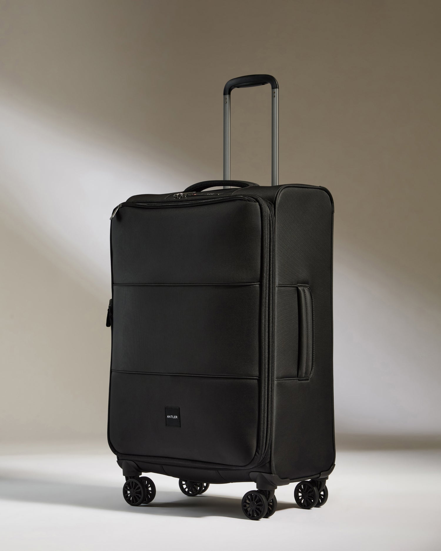 Lightest Medium Luggage in Black - Soft Stripe